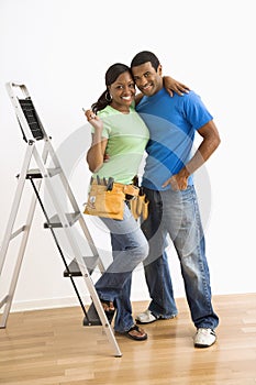 Portrait of couple with ladder.