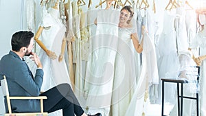 Portrait of couple love or bride in wedding studio while try to fitting suit and dress with bouquet flowers as romantic people