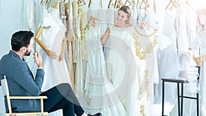 Portrait of couple love or bride in wedding studio while try to fitting suit and dress with bouquet flowers as romantic people