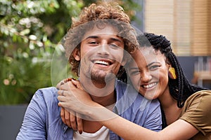 Portrait, couple and lovers with embrace, smile and love outdoors in garden, backyard and patio. Male person, black