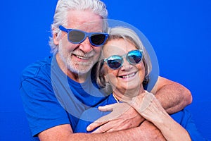Portrait of couple of mature people or seniors together having fun smiling and looking at the camera - woman and man pensioners