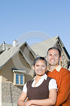 Portrait of a couple outside of a house photo