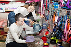 Portrait of couple purchasing pet bowls in petshop