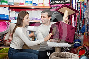 Portrait of couple purchasing pet kennels in petshop