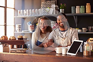 Portrait Of Couple Running Coffee Shop Behind Counter