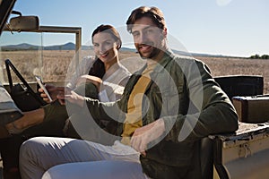 Portrait of couple sitting in off road vehicle