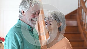 Portrait of couple of two happy and healthy seniors old people smiling and looking at the camera. Close up of mature grandparents