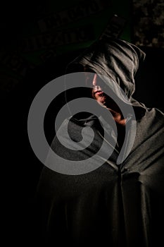 Portrait of a courageous warrior wanderer in a black cloak. Historical fantasy. Halloween