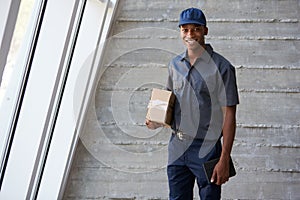 Portrait Of Courier Collecting Package From Office