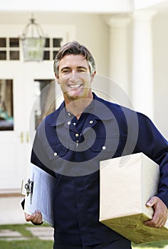 Portrait Of Courier Delivering Package