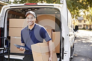 Portrait Of Courier With Digital Tablet Delivering Package