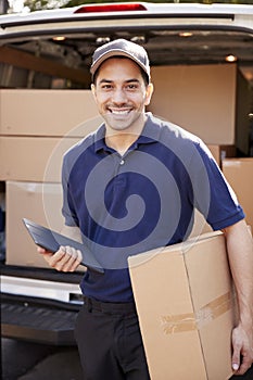 Portrait Of Courier With Digital Tablet Delivering Package