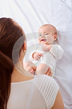 Portrait of a crawling baby on the bed in her room