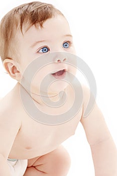 Portrait of crawling baby boy looking up