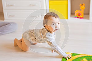 Portrait of crawling funny baby boy indoors at home