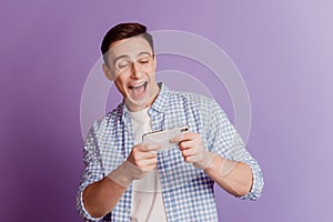 Portrait of crazy charismatic funky guy direct fingers you open mouth on violet background