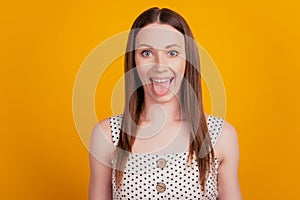 Portrait of crazy funky lady protrude healthy tongue on yellow background photo