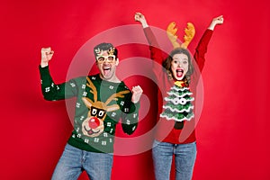 Portrait of crazy funny two family wife husband brown hair celebrate victory raise fists scream yes wear christmas tree