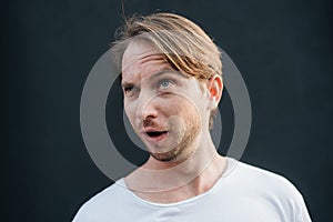 Portrait of crazy man at dark wall