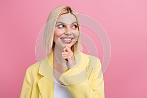 Portrait of creative gorgeous girl toothy smile arm touch chin look empty space isolated on pink color background