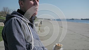 Portrait cripple close-up eats shawarma, lonesome male disabled on