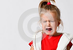 Portrait of crying, yelling, abused kid girl after family conflict. Got lost. Family conflict, violence, defenseless