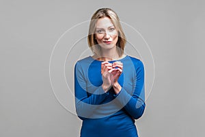 Portrait of cunning beautiful businesswoman planning evil tricky prank. isolated on gray background