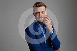 Portrait of curious smart casual man looking to side