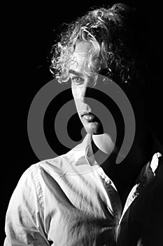 Portrait of a curly-haired blond man. Style, model, glamor