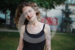 Portrait of curly-haired woman on the street