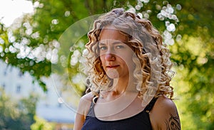 Portrait of curly-haired woman on the street