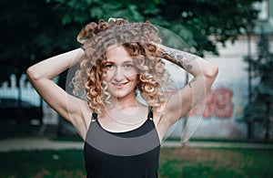 Portrait of curly-haired woman on the street