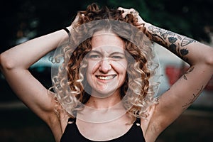 Portrait of curly-haired woman on the street