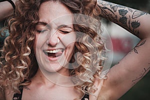 Portrait of curly-haired woman on the street