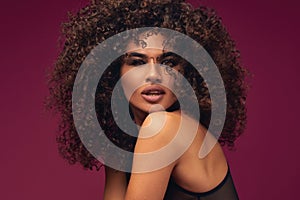 Portrait of curly model on bright background