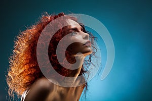 Portrait of a curly red hair woman