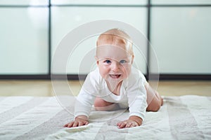 Portrait of a cute 6 months baby boy crawling on the floor