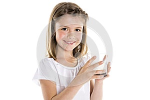 Portrait of a cute 7 years old girl Isolated over white background with milk glass