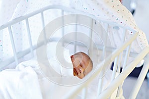 Portrait of cute adorable newborn baby girl in birth hospital.