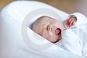 Portrait of cute adorable newborn baby girl scrying