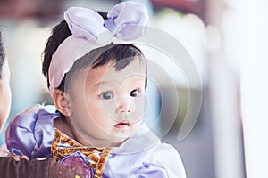 Portrait of cute asian baby girl wearing beautiful bow