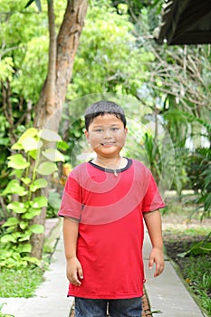 Portrait of cute asian boy smiling in the park