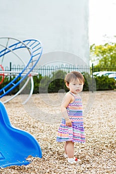 Portrait of cute Asian child playing in park