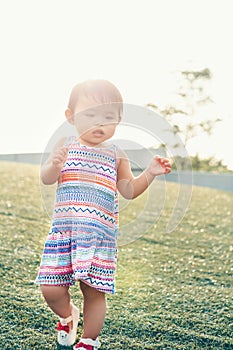 Portrait of cute Asian child playing in park