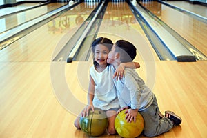 Portrait cute asia little child girl and boy playing bowling