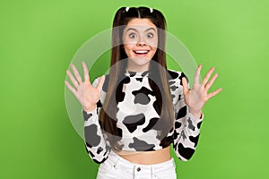 Portrait of cute astonished person toothy smile raise opened arms palms cant believe isolated on green color background