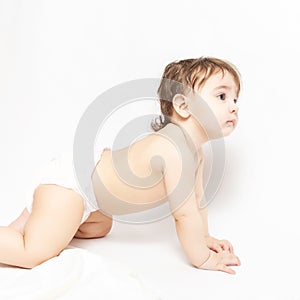 Portrait of a cute baby 9 months crawling on the floor