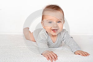 Portrait of a cute baby boy with blue eyes on white background