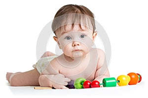 Portrait of cute baby boy with developmental wooden toys. photo