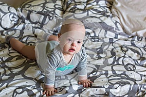 Portrait of cute baby boy with Down syndrome